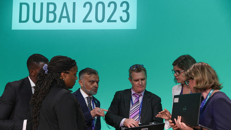 Negotiators huddle around a document at Cop2